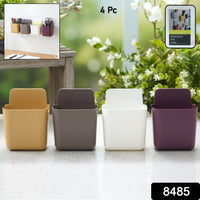 Four mixed-colour Wall Mounted Mobile Holders on a smooth, clean wall surface.