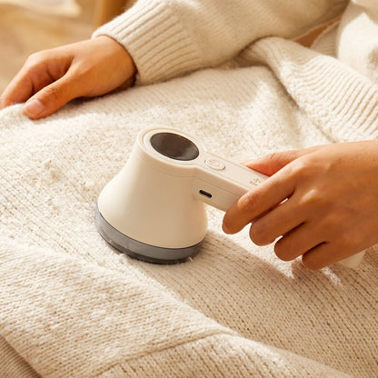 Fabric shaver in use on a sweater