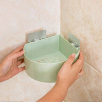 Self adhesive corner shelf installed in a modern bathroom.