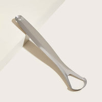 Stainless steel tongue scraper with its metal travel case.