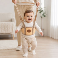 Baby walking support harness in a neutral colour for toddler first steps