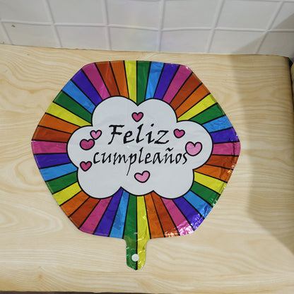 Party decor with shiny Feliz Cumpleanos foil balloon