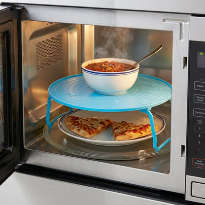 Elevated spacer tray for microwave cooking and serving